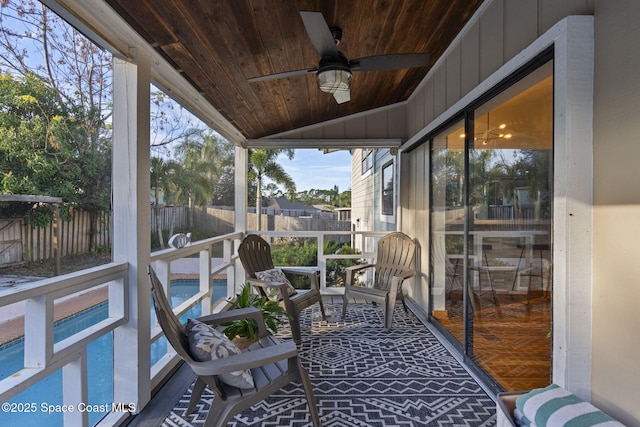 sunroom featuring ceiling fan, vaulted ceiling, and wooden ceiling