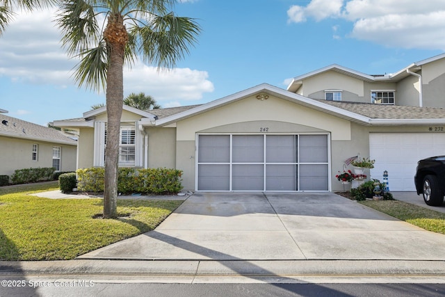 view of front of home featuring a garage and a front yard