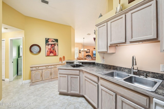 kitchen featuring light tile patterned flooring, light brown cabinetry, sink, and kitchen peninsula