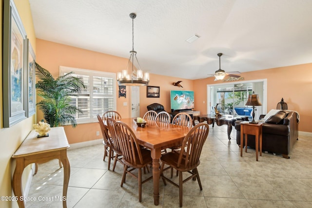 dining room featuring light tile patterned flooring, lofted ceiling, and plenty of natural light