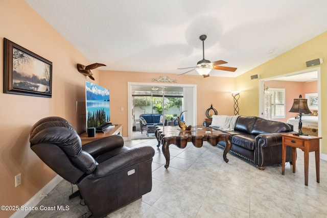 tiled living room featuring ceiling fan, lofted ceiling, and a wealth of natural light