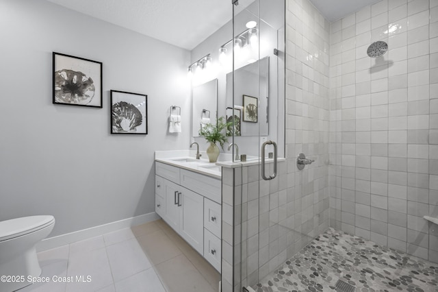 bathroom featuring vanity, toilet, tile patterned floors, and a shower with shower door