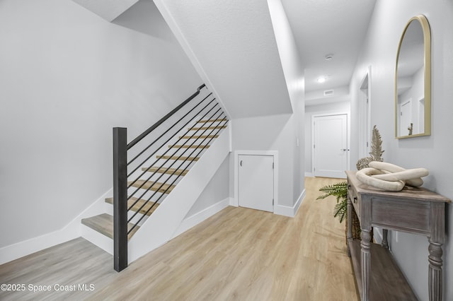 staircase with hardwood / wood-style flooring