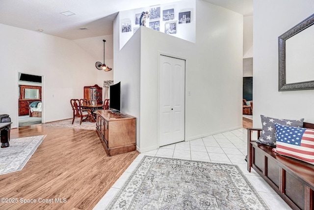 tiled entryway featuring high vaulted ceiling