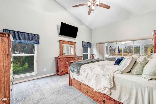 carpeted bedroom featuring ceiling fan and high vaulted ceiling