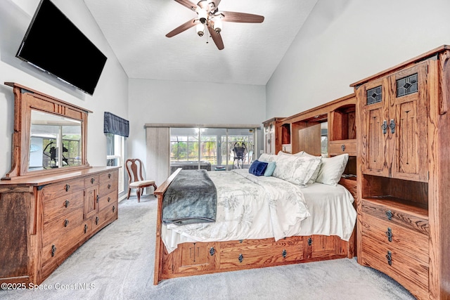 bedroom with a textured ceiling, light carpet, lofted ceiling, and ceiling fan