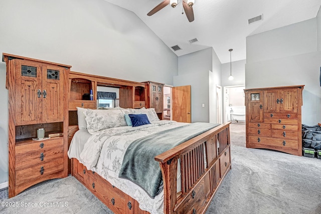 carpeted bedroom with ceiling fan and high vaulted ceiling