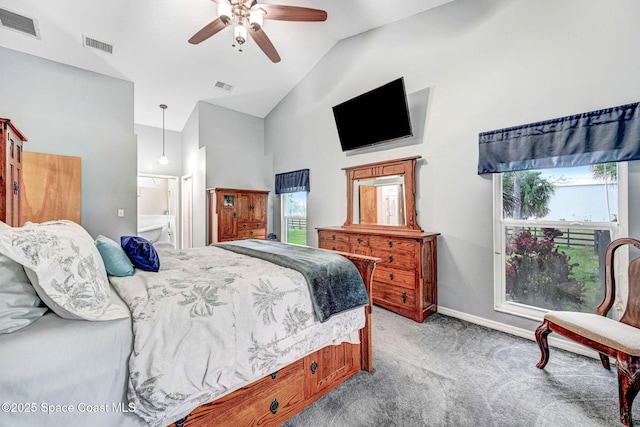 bedroom with connected bathroom, high vaulted ceiling, ceiling fan, and light colored carpet