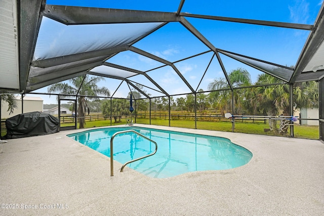 view of swimming pool with a yard, glass enclosure, grilling area, and a patio area