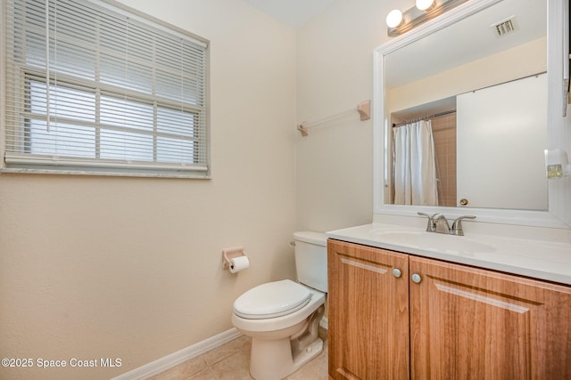 bathroom with vanity, tile patterned floors, and toilet