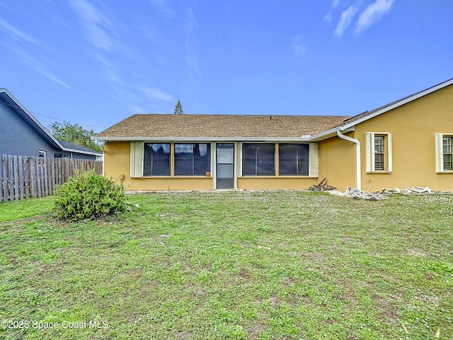 back of property featuring a lawn