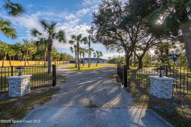 view of gate featuring a yard