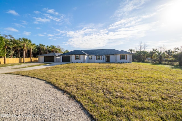 ranch-style house with a garage and a front yard