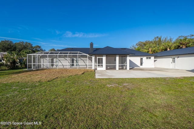 rear view of property featuring a yard and a patio area