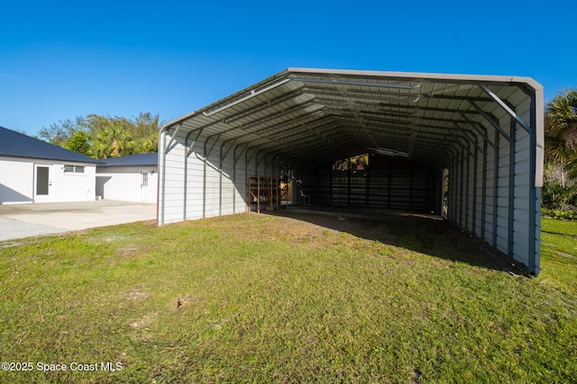 view of outbuilding with a yard and a carport