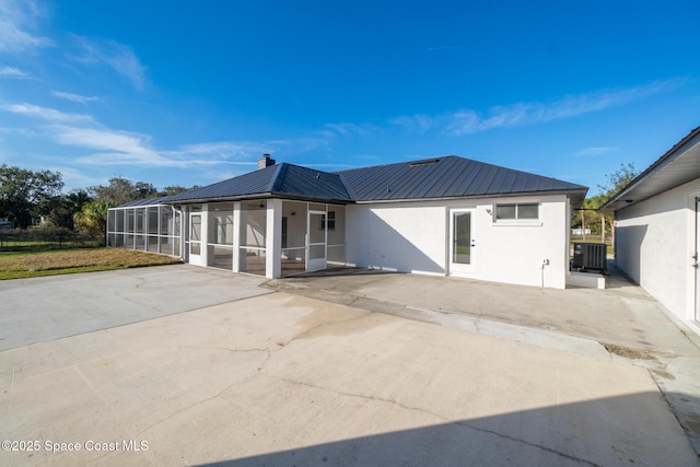 back of property featuring a sunroom, a lanai, a patio, and central air condition unit