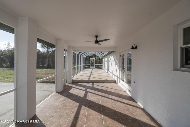 view of patio featuring a lanai and ceiling fan