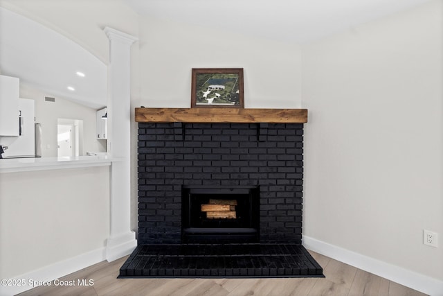 room details featuring a fireplace and wood-type flooring