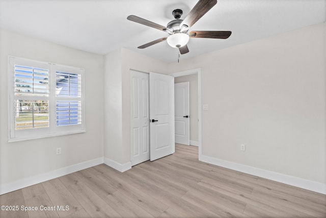 unfurnished bedroom with ceiling fan, a closet, and light hardwood / wood-style flooring