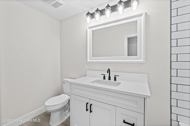 bathroom featuring vanity, wood-type flooring, and toilet