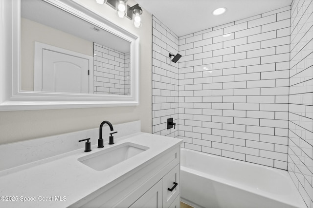 bathroom featuring vanity and tiled shower / bath combo