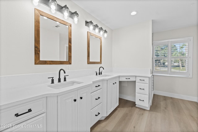 bathroom featuring hardwood / wood-style flooring and vanity