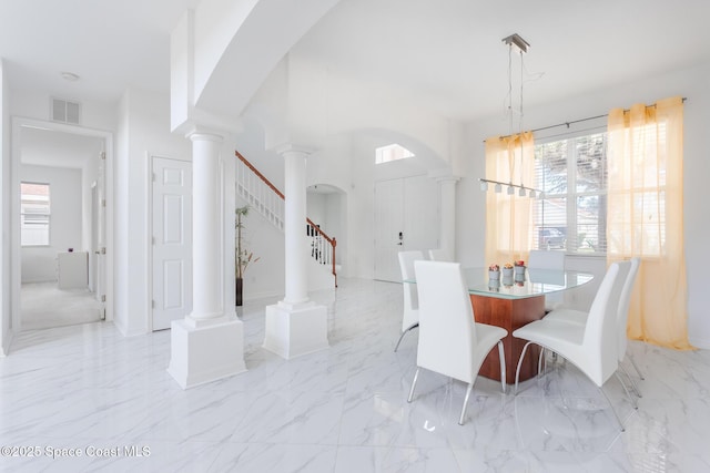 dining area featuring ornate columns