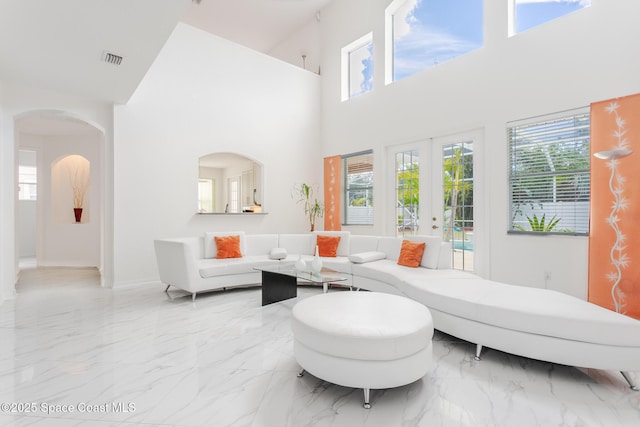 living room featuring a high ceiling and french doors