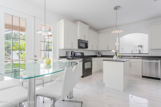 kitchen with white cabinetry, sink, pendant lighting, and black appliances