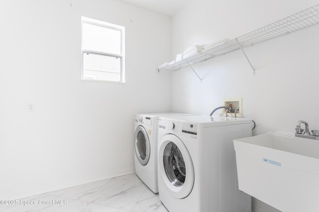 laundry area featuring separate washer and dryer and sink