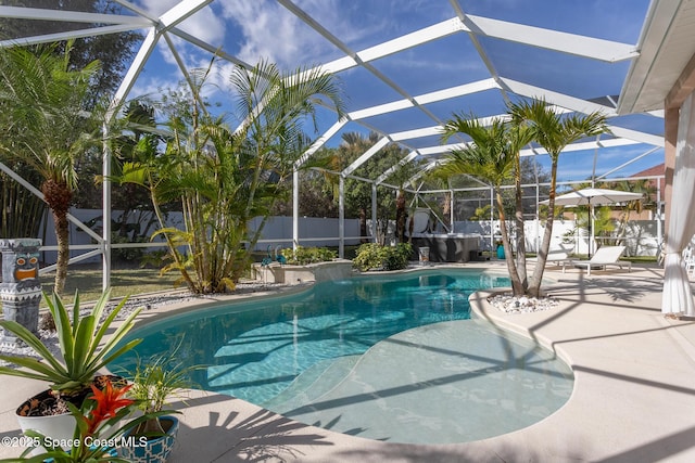 view of pool with a patio and glass enclosure