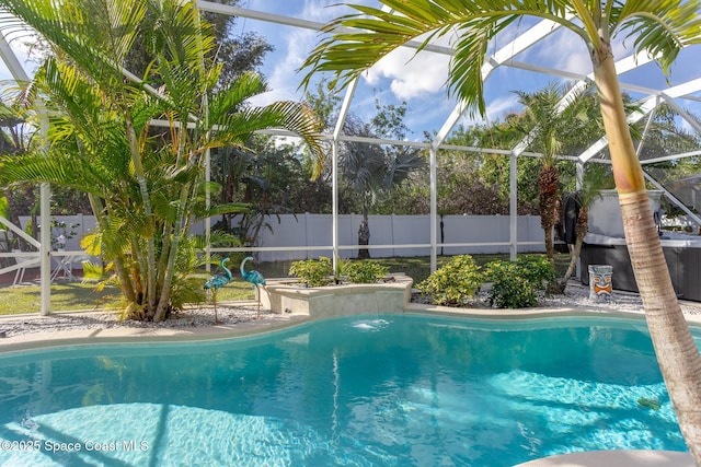 view of swimming pool with glass enclosure