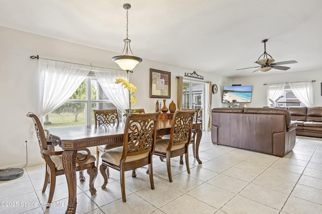 dining space with ceiling fan and light tile patterned flooring