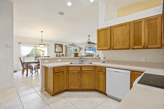 kitchen featuring sink, hanging light fixtures, light tile patterned floors, white dishwasher, and kitchen peninsula