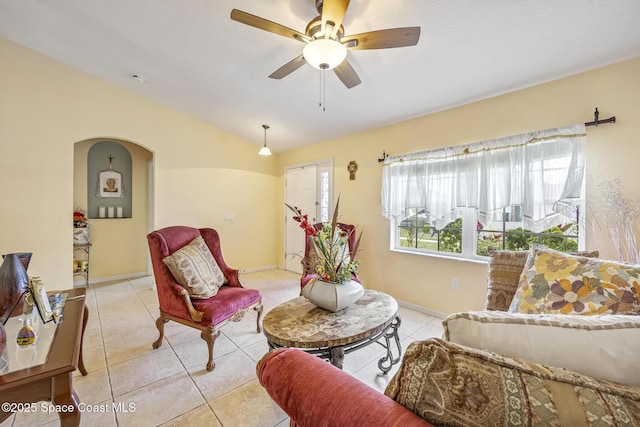 tiled living room featuring vaulted ceiling and ceiling fan