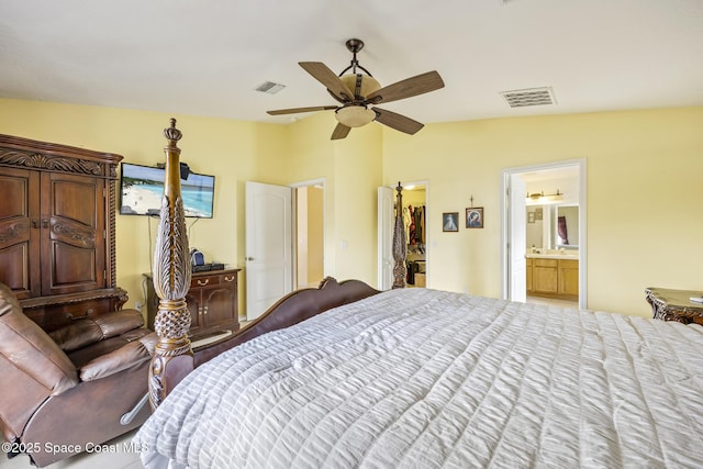 bedroom with a walk in closet, vaulted ceiling, ceiling fan, and ensuite bathroom