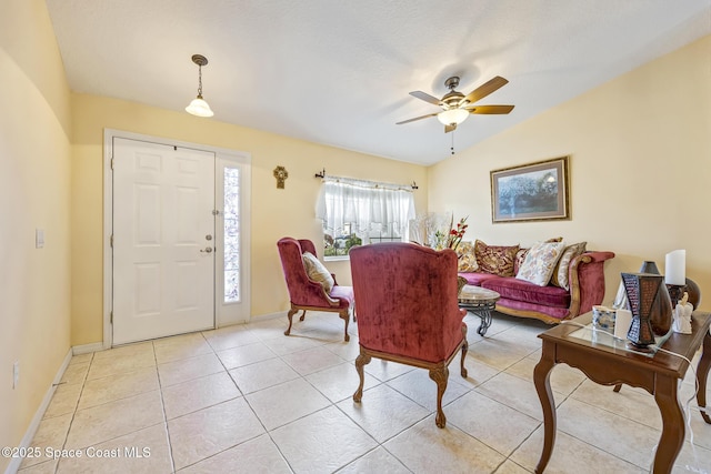 living room featuring light tile patterned flooring, vaulted ceiling, and ceiling fan