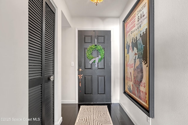 entryway with dark wood-type flooring