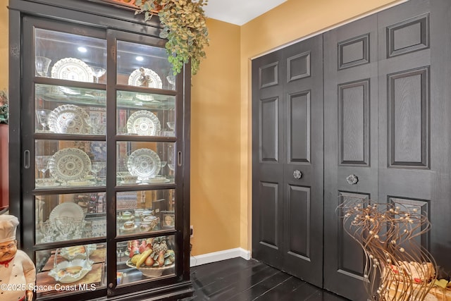 entryway with dark hardwood / wood-style flooring