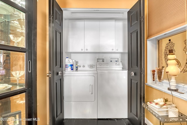 laundry area featuring cabinets and washing machine and clothes dryer