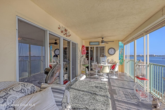 exterior space with a water view and ceiling fan