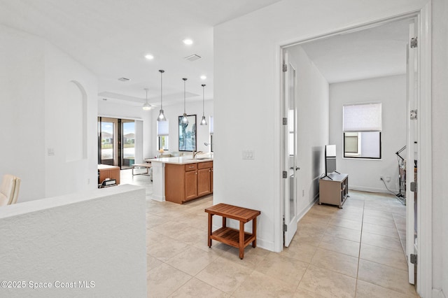 hall with sink and light tile patterned floors