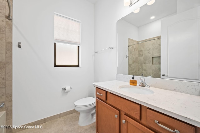 bathroom featuring tiled shower, vanity, toilet, and tile patterned floors