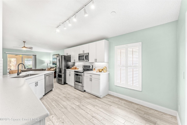 kitchen featuring white cabinetry, appliances with stainless steel finishes, and sink