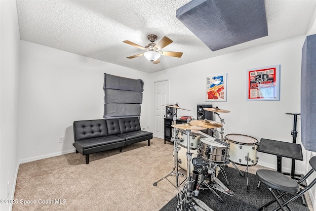 interior space featuring light carpet, a textured ceiling, and ceiling fan