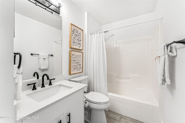 full bathroom featuring hardwood / wood-style flooring, shower / tub combo with curtain, vanity, and toilet