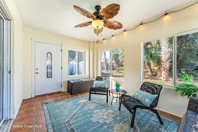 sunroom featuring ceiling fan