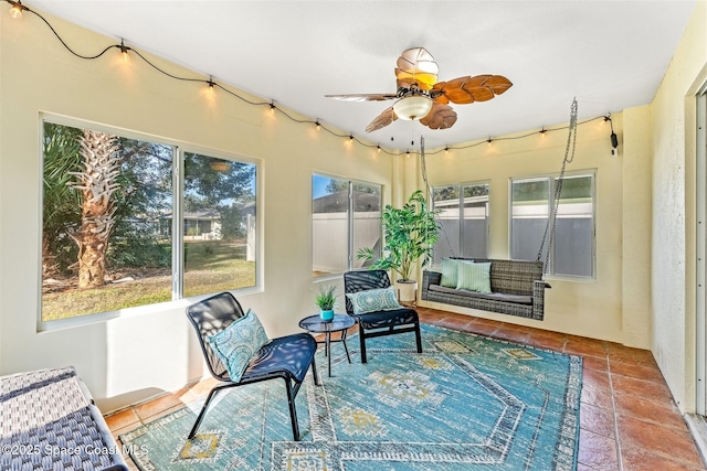 sunroom featuring ceiling fan