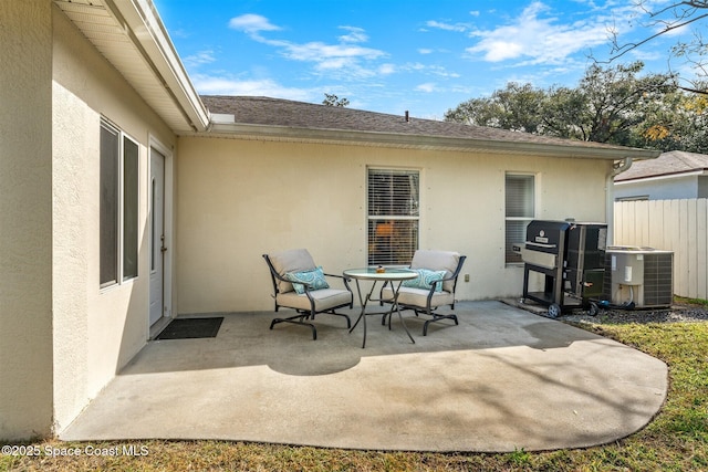 view of patio with area for grilling and central AC