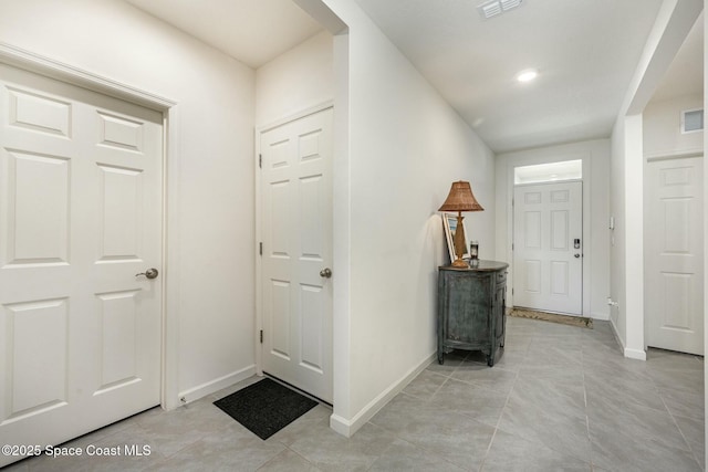 foyer entrance with light tile patterned floors